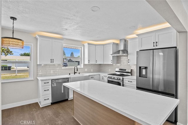 1514 E Palm Ave, Orange, CA 92866 - kitchen featuring appliances with stainless steel finishes, wall chimney range hood, healthy amount of natural light, decorative backsplash, and a textured ceiling