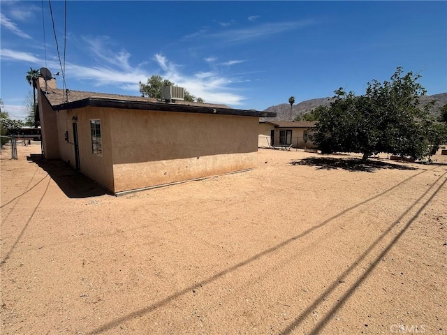 6162 Chia Ave Unit 29, Palms, CA 92277 - view of side of home with stucco siding and a mountain view