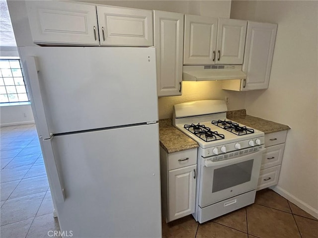 6162 Chia Ave Unit 29, Palms, CA 92277 - kitchen featuring white appliances, under cabinet range hood, light tile patterned floors, white cabinets, and light stone countertops