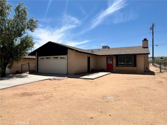 6162 Chia Ave Unit 29, Palms, CA 92277 - ranch-style home featuring a garage, concrete driveway, and a chimney