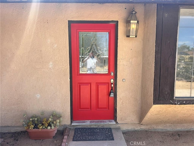 6162 Chia Ave Unit 29, Palms, CA 92277 - doorway to property with stucco siding