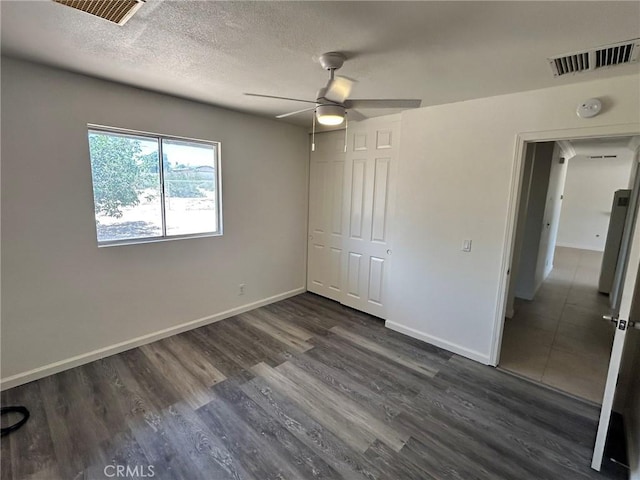6162 Chia Ave Unit 29, Palms, CA 92277 - unfurnished bedroom featuring dark wood finished floors, a closet, ceiling fan, and a textured ceiling