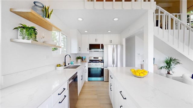 496 Crane Blvd, Los Angeles, CA 90065 - kitchen featuring appliances with stainless steel finishes, open shelves, light wood-style floors, recessed lighting, and white cabinetry