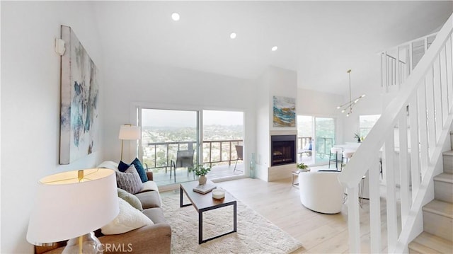496 Crane Blvd, Los Angeles, CA 90065 - living room with a towering ceiling, stairs, wood finished floors, recessed lighting, and a fireplace