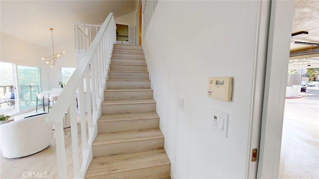 496 Crane Blvd, Los Angeles, CA 90065 - stairs featuring a chandelier and wood finished floors
