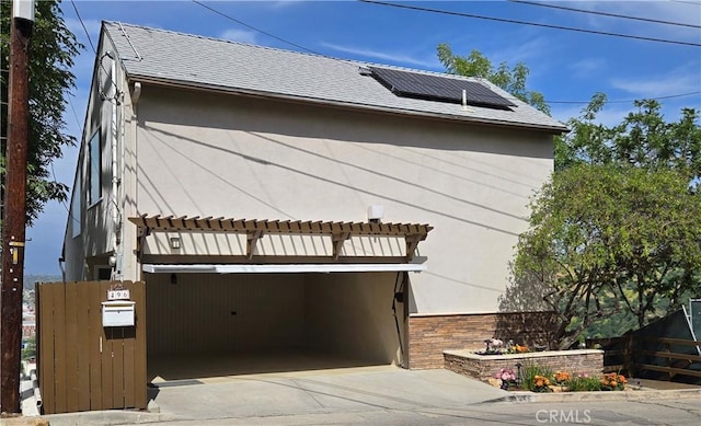 496 Crane Blvd, Los Angeles, CA 90065 - view of property exterior featuring solar panels, roof with shingles, and stucco siding