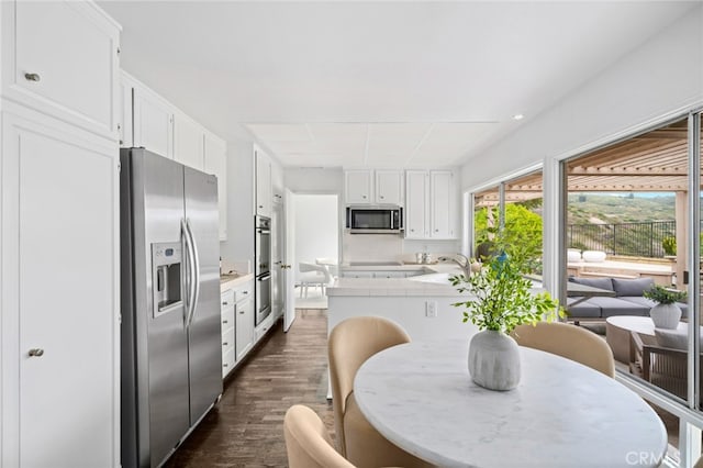 1606 Reef View Cir, Corona Del Mar, CA 92625 - kitchen featuring appliances with stainless steel finishes, dark wood-style floors, white cabinetry, and light countertops