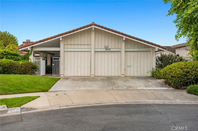 1606 Reef View Cir, Corona Del Mar, CA 92625 - view of front of home with a garage, a tiled roof, concrete driveway, board and batten siding, and a front lawn