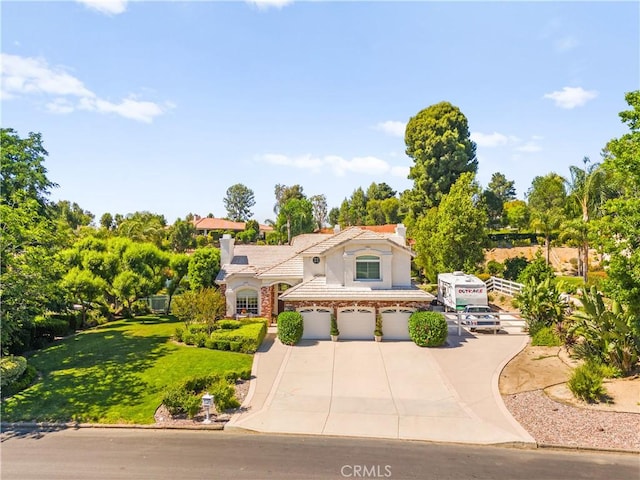 31148 Kahwea Rd, Temecula, CA 92591 - mediterranean / spanish-style home with a garage, stucco siding, a chimney, concrete driveway, and a tile roof
