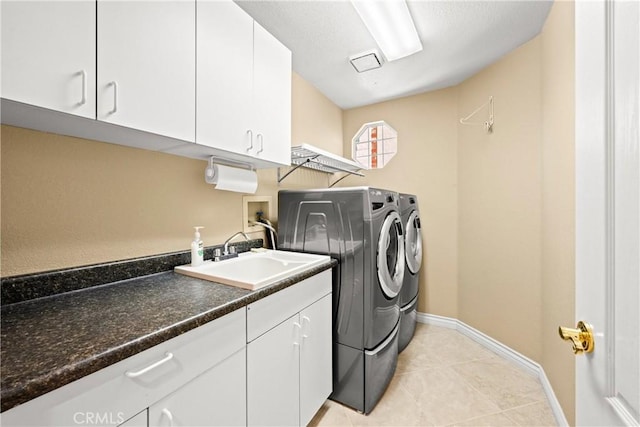 31148 Kahwea Rd, Temecula, CA 92591 - laundry area featuring separate washer and dryer, light tile patterned flooring, and cabinet space