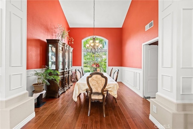31148 Kahwea Rd, Temecula, CA 92591 - dining area featuring a chandelier, a wainscoted wall, hardwood / wood-style flooring, and high vaulted ceiling