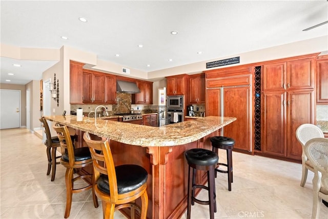 31148 Kahwea Rd, Temecula, CA 92591 - kitchen featuring built in appliances, a peninsula, tasteful backsplash, wall chimney range hood, and light stone counters