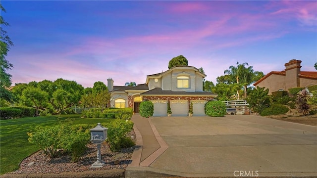 31148 Kahwea Rd, Temecula, CA 92591 - view of front of property featuring an attached garage, concrete driveway, a yard, and stucco siding