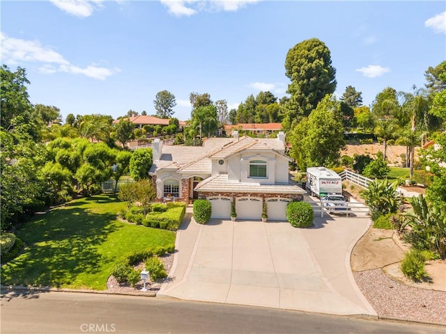 31148 Kahwea Rd, Temecula, CA 92591 - mediterranean / spanish house with driveway, a garage, stucco siding, a tiled roof, and a front yard
