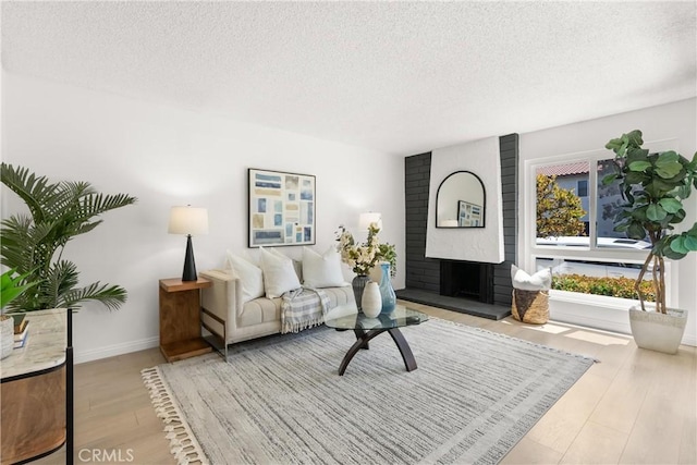 11338 Grand Manan Dr, Cypress, CA 90630 - living area with a fireplace, a textured ceiling, and wood finished floors