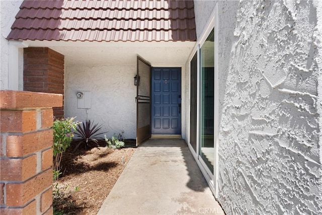 11338 Grand Manan Dr, Cypress, CA 90630 - property entrance with a tiled roof and stucco siding