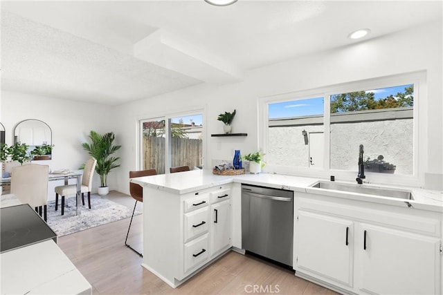 11338 Grand Manan Dr, Cypress, CA 90630 - kitchen featuring dishwasher, a peninsula, white cabinetry, light countertops, and recessed lighting