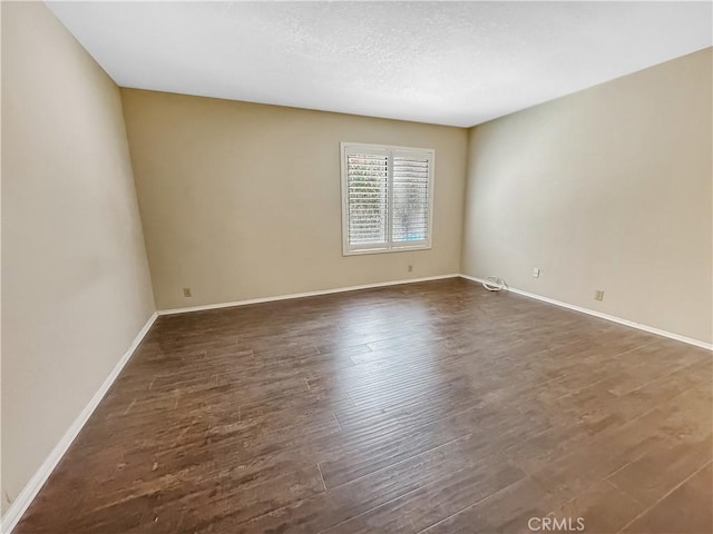 600 Central Ave Unit 323, Riverside, CA 92507 - spare room with dark wood finished floors and a textured ceiling