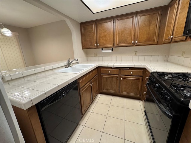 600 Central Ave Unit 323, Riverside, CA 92507 - kitchen with black appliances, a peninsula, light tile patterned flooring, tile countertops, and brown cabinets