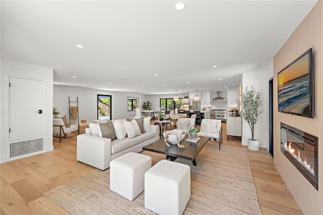 31842 Paseo Cielo, San Juan Capistrano, CA 92675 - living room featuring recessed lighting, light wood-style floors, and a glass covered fireplace