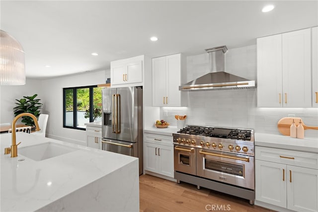 31842 Paseo Cielo, San Juan Capistrano, CA 92675 - kitchen featuring high quality appliances, wall chimney range hood, decorative backsplash, white cabinets, and recessed lighting