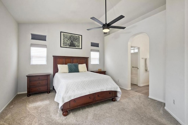 339 Diamante Way, Oceanside, CA 92056 - carpeted bedroom featuring arched walkways, lofted ceiling, connected bathroom, and a ceiling fan