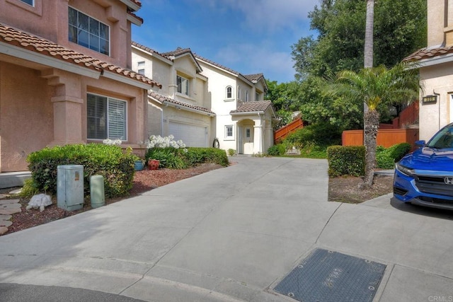 339 Diamante Way, Oceanside, CA 92056 - view of front of house featuring driveway, a tiled roof, stucco siding, and an attached garage