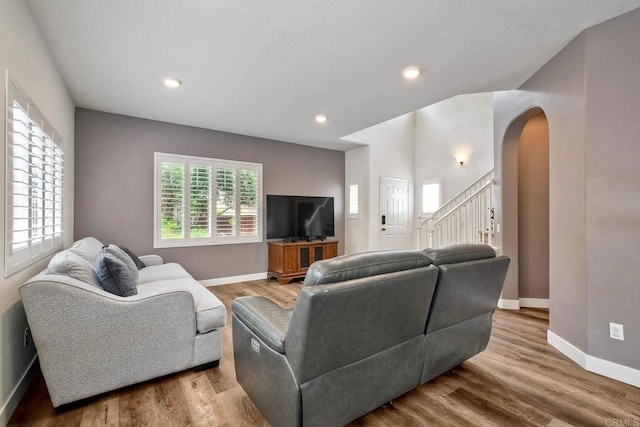 339 Diamante Way, Oceanside, CA 92056 - living room featuring arched walkways, stairs, wood finished floors, and recessed lighting