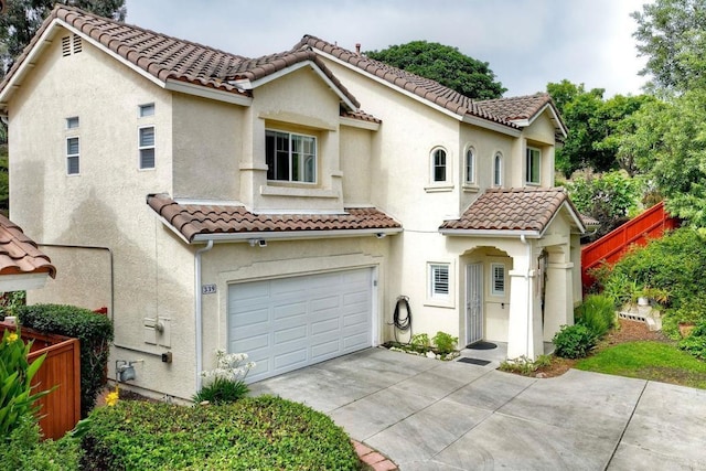 339 Diamante Way, Oceanside, CA 92056 - mediterranean / spanish house featuring concrete driveway, a tile roof, an attached garage, and stucco siding