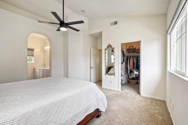 339 Diamante Way, Oceanside, CA 92056 - bedroom featuring lofted ceiling, light carpet, multiple windows, a spacious closet, and arched walkways