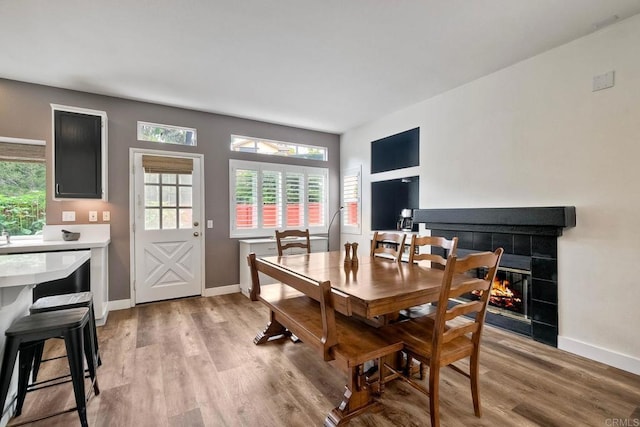 339 Diamante Way, Oceanside, CA 92056 - dining area with light wood-style flooring, plenty of natural light, and a tile fireplace