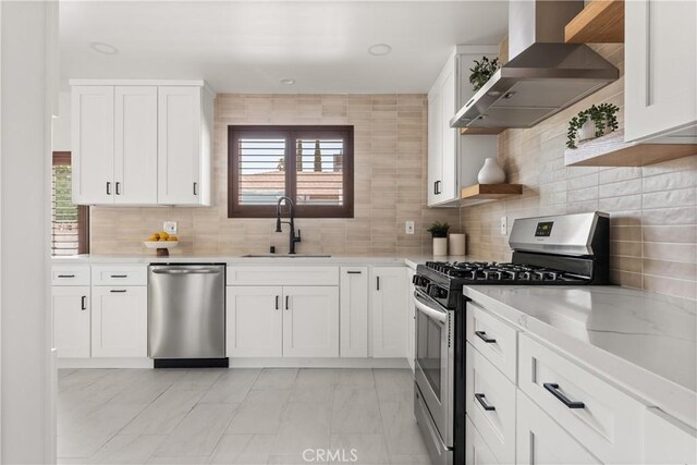933 N Lincoln St, Burbank, CA 91506 - kitchen featuring wall chimney range hood, appliances with stainless steel finishes, white cabinets, and tasteful backsplash