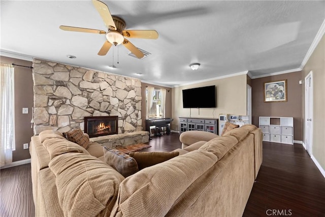 2818 Renegade Ave, Bakersfield, CA 93306 - living area with crown molding, a ceiling fan, dark wood finished floors, and a stone fireplace