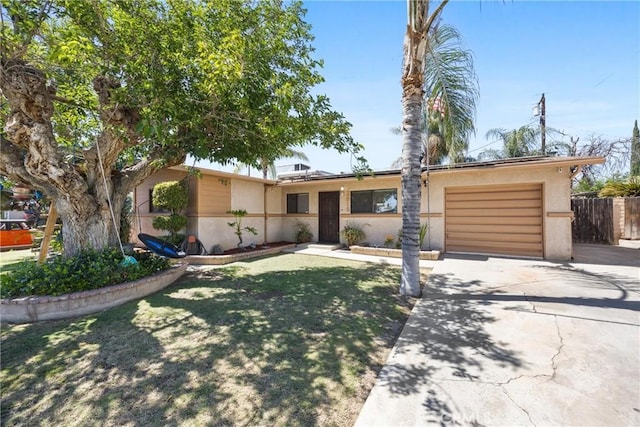 2818 Renegade Ave, Bakersfield, CA 93306 - ranch-style house with driveway, a garage, and stucco siding