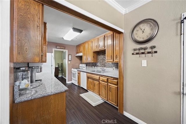 2818 Renegade Ave, Bakersfield, CA 93306 - kitchen with white appliances, decorative backsplash, ornamental molding, dark wood-type flooring, and light stone counters