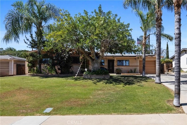 2818 Renegade Ave, Bakersfield, CA 93306 - view of front of house with a front yard, a garage, and stucco siding