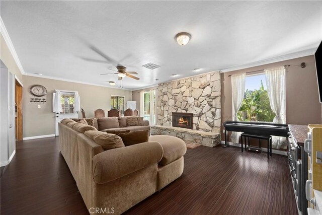 2818 Renegade Ave, Bakersfield, CA 93306 - living room with crown molding, ceiling fan, a stone fireplace, and dark wood-style floors