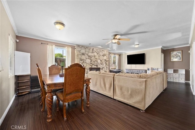 2818 Renegade Ave, Bakersfield, CA 93306 - dining space featuring a ceiling fan, ornamental molding, dark wood finished floors, and a fireplace