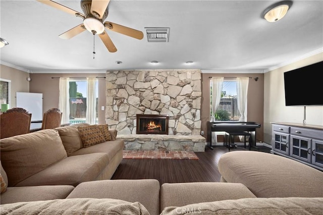 2818 Renegade Ave, Bakersfield, CA 93306 - living area with ornamental molding, healthy amount of natural light, ceiling fan, wood finished floors, and a stone fireplace