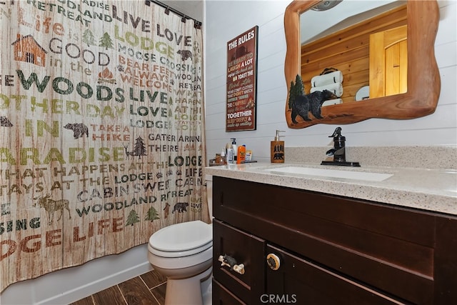 721 Riverside Ave, Sugarloaf, CA 92386 - full bathroom featuring vanity, wood walls, shower / bath combo with shower curtain, and wood finished floors