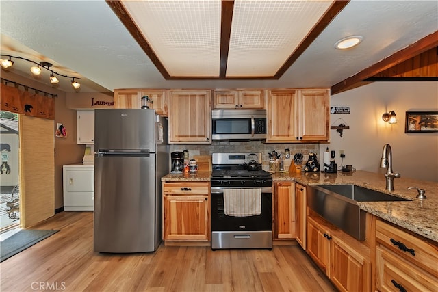 721 Riverside Ave, Sugarloaf, CA 92386 - kitchen featuring stainless steel appliances, washer / clothes dryer, backsplash, light stone counters, and light wood-style floors