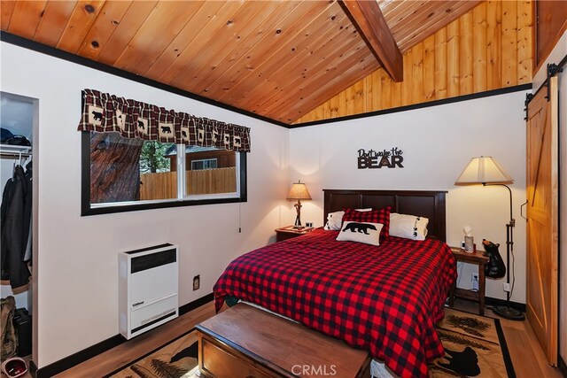 721 Riverside Ave, Sugarloaf, CA 92386 - bedroom with a barn door, wood finished floors, wooden ceiling, and heating unit