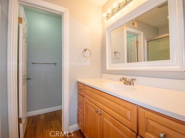 4674 Maxwell Ct, Riverside, CA 92501 - full bath featuring vanity, wood finished floors, and an enclosed shower