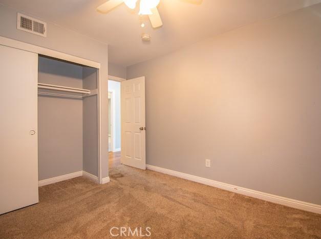 4674 Maxwell Ct, Riverside, CA 92501 - unfurnished bedroom with carpet, a closet, and ceiling fan