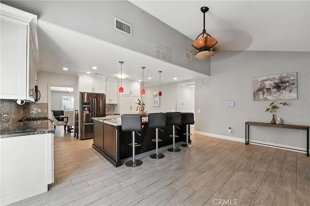 1817 Balboa Way, Upland, CA 91784 - kitchen featuring stainless steel refrigerator with ice dispenser, light wood-style flooring, white cabinets, tasteful backsplash, and recessed lighting