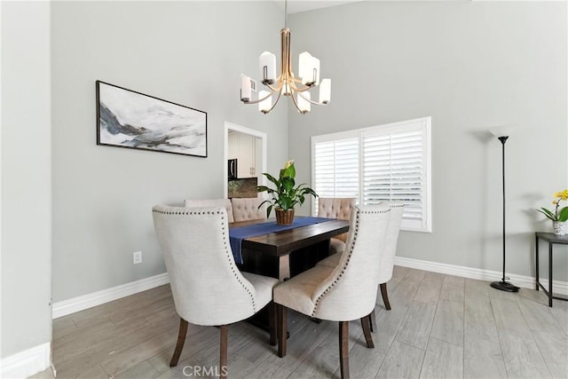 1817 Balboa Way, Upland, CA 91784 - dining area featuring a chandelier, light wood-style flooring, and a high ceiling