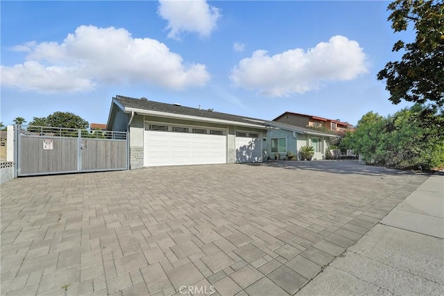 1817 Balboa Way, Upland, CA 91784 - view of front of house with a garage, decorative driveway, a gate, and stone siding