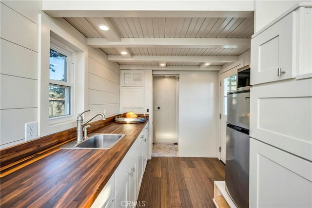 21018 Yankee Valley Rd, Hidden Valley Lake, CA 95467 - kitchen with wooden counters, freestanding refrigerator, dark wood-style flooring, plenty of natural light, and a wooden ceiling with exposed beams