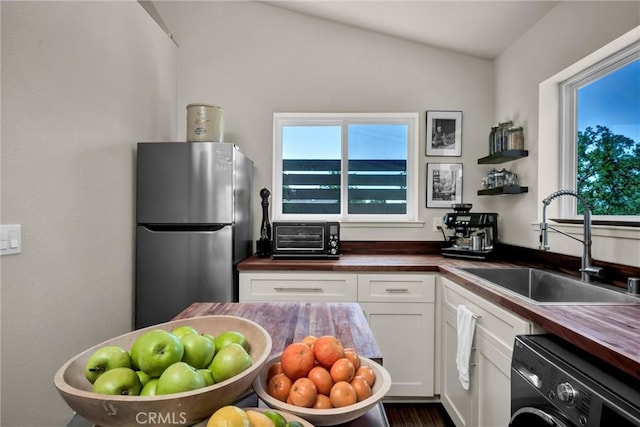 21018 Yankee Valley Rd, Hidden Valley Lake, CA 95467 - kitchen featuring freestanding refrigerator, butcher block counters, washer / dryer, and white cabinetry