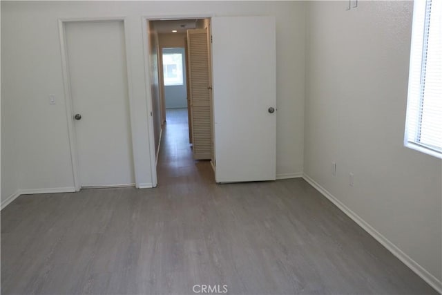 80 Greenmoor Unit 40, Irvine, CA 92614 - unfurnished bedroom featuring wood finished floors and baseboards